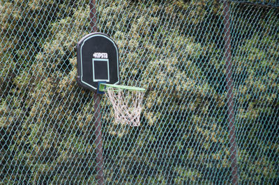 Close-up of sign on chainlink fence