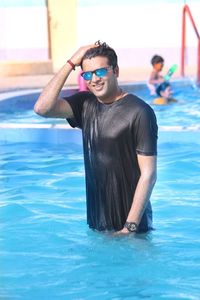 Portrait of young man swimming in pool