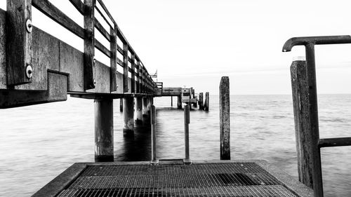 Pier over sea against clear sky