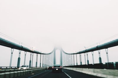 Car on verrazano–narrows bridge against sky during foggy weather