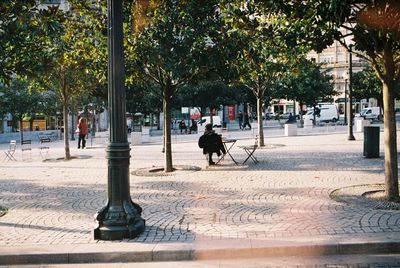 Man on bench in city