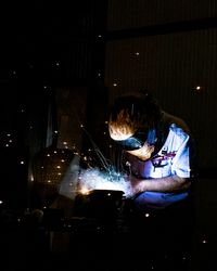 Man working in illuminated room