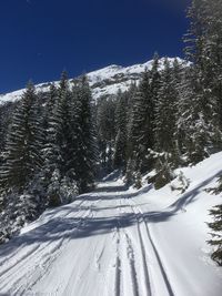 Snow covered landscape against sky