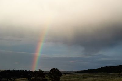 Rainbow over landscape against sky