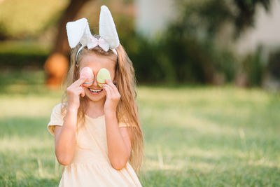 Portrait of girl wearing mask on field