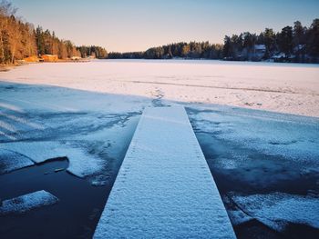 Snowy pier on a winter lake