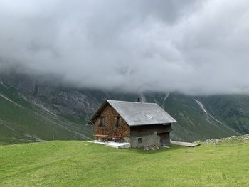 House on mountain against sky