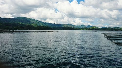 Scenic view of lake against cloudy sky