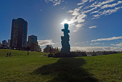 Panoramic view of sculpture on field against sky