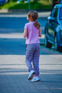 Rear view of girl on road