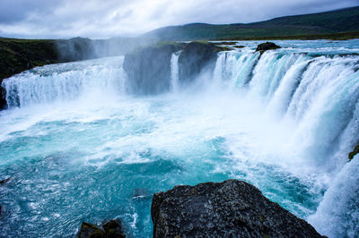 Waterfall godafoss with blue water in iceland. landscape.