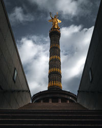 Low angle view of statue against cloudy sky