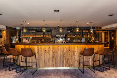 Empty chairs and tables in restaurant