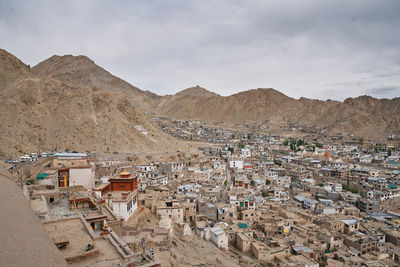 High angle view of houses and mountains against sky