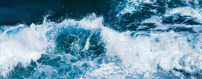 High angle view of waves splashing in sea