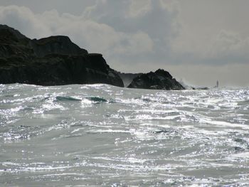 Scenic view of sea against cloudy sky