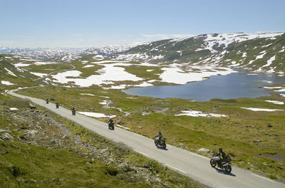 People on motorbikes in mountainous landscape