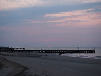 Scenic view of beach against sky during sunset