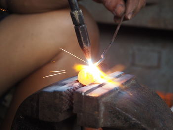 Person holding burning candles