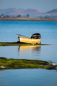 Boat in lake against sky