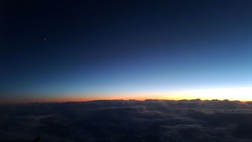 Scenic view of mountains against clear sky at sunset