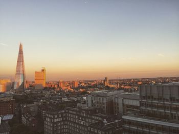 View of cityscape against clear sky during sunset