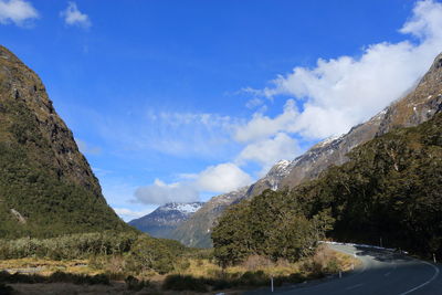 Scenic view of mountains against blue sky