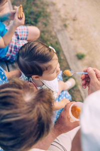 Rear view of people holding ice cream