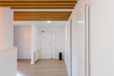 A reception of modern office with lights and wood on the ceiling