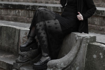 Low section of woman sitting on floor