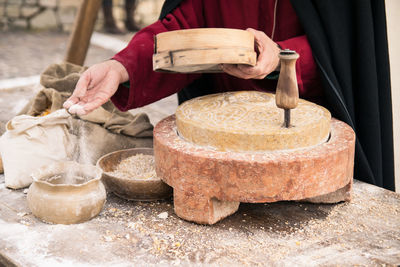 Midsection of man preparing food