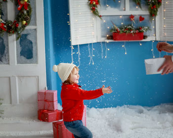Rear view of woman holding christmas tree