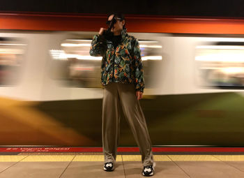 Rear view of woman walking on railroad station