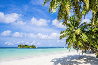 Single tropical island with blue sky and turquoise water, seychelles