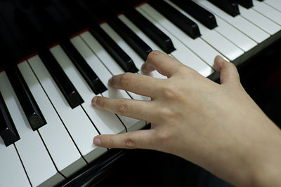 Cropped hand playing piano