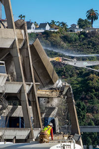 People working on construction site by building