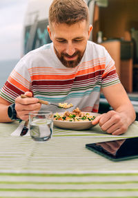 Smiling man eating food