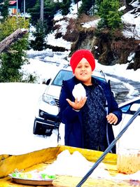 Portrait of woman with ice cream in winter