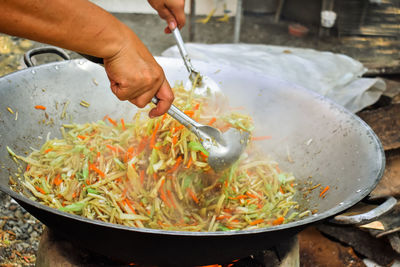 Cropped image of person preparing food