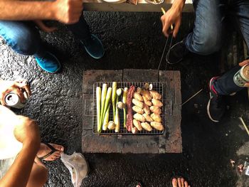 Low section of people holding food