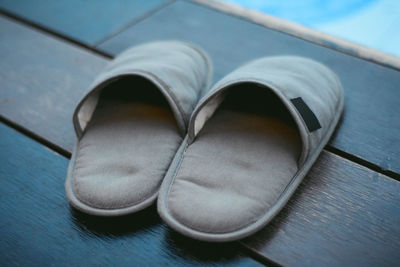 Close-up of slippers on wooden floor