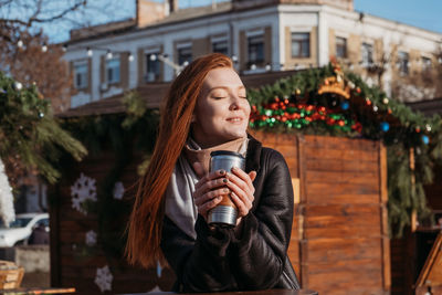 Portrait of young woman drinking coffee