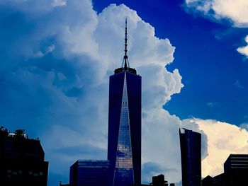 Low angle view of buildings against cloudy sky