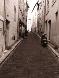 Alley amidst street in city