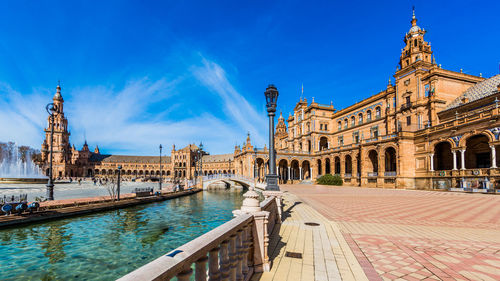 View of the building in plaza de españa against blue sky in seville, spain