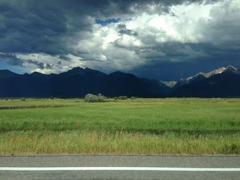 Scenic view of landscape against cloudy sky