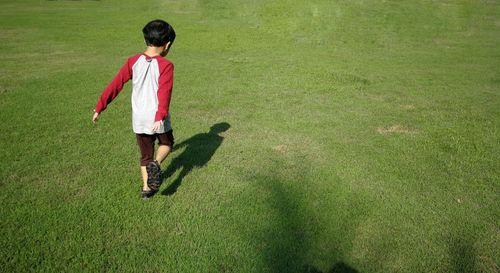 Full length of man standing in lawn