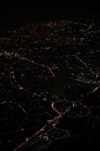 Aerial view of illuminated cityscape against sky at night