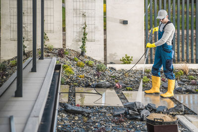 Low section of man standing in greenhouse