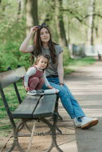 Young woman sitting on bench at park